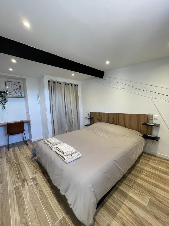 a bedroom with a large bed and a desk at Villa Corbelle - Grand Studio in Cannes