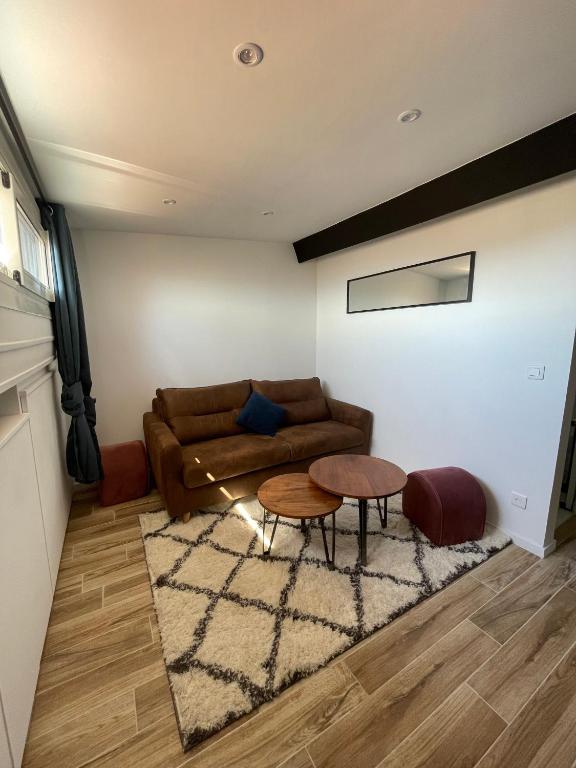 a living room with a couch and a table at Villa Corbelle - Grand Studio in Cannes