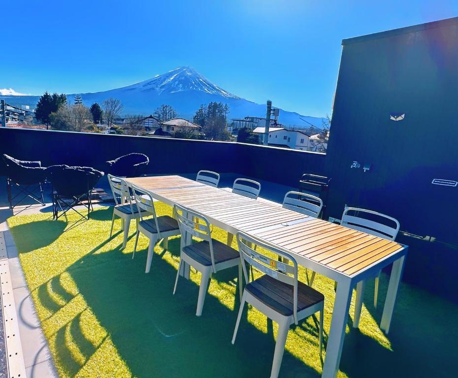 uma mesa e cadeiras com uma montanha ao fundo em ヴィラ山間堂 Terrace Villa BBQ Bonfire Fuji view Annovillas em Fujikawaguchiko