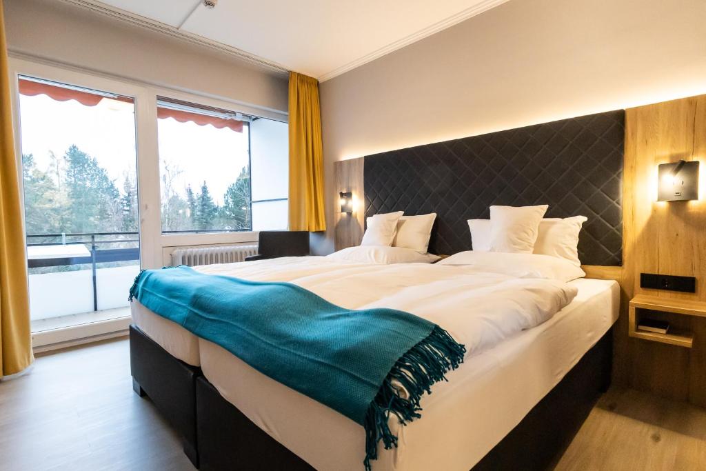 Postel nebo postele na pokoji v ubytování VitalHotel Ascona