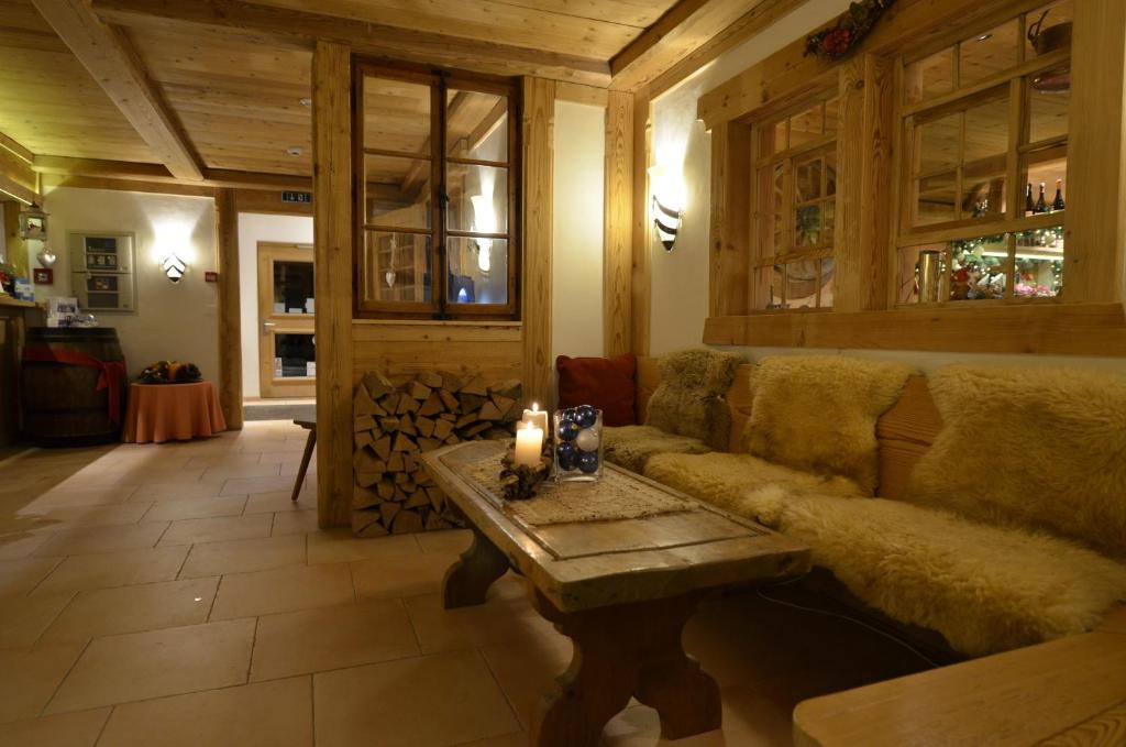 a living room with a couch and a table with a candle at Hotel Bellerive Gstaad in Gstaad