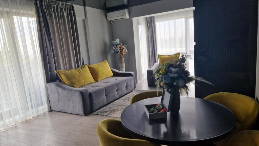 a living room with a couch and a table with yellow pillows at Alecsa 1 Luxury Residence in Mamaia