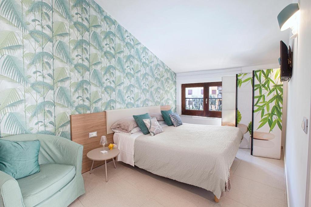 1 dormitorio con 1 cama y 1 silla azul en Estate4home - Casa Cristina, en Sorrento
