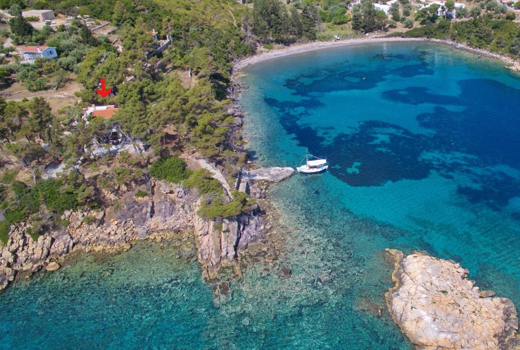 an aerial view of a beach with a boat in the water at Kavos Villa in Aghios Petros Alonissos
