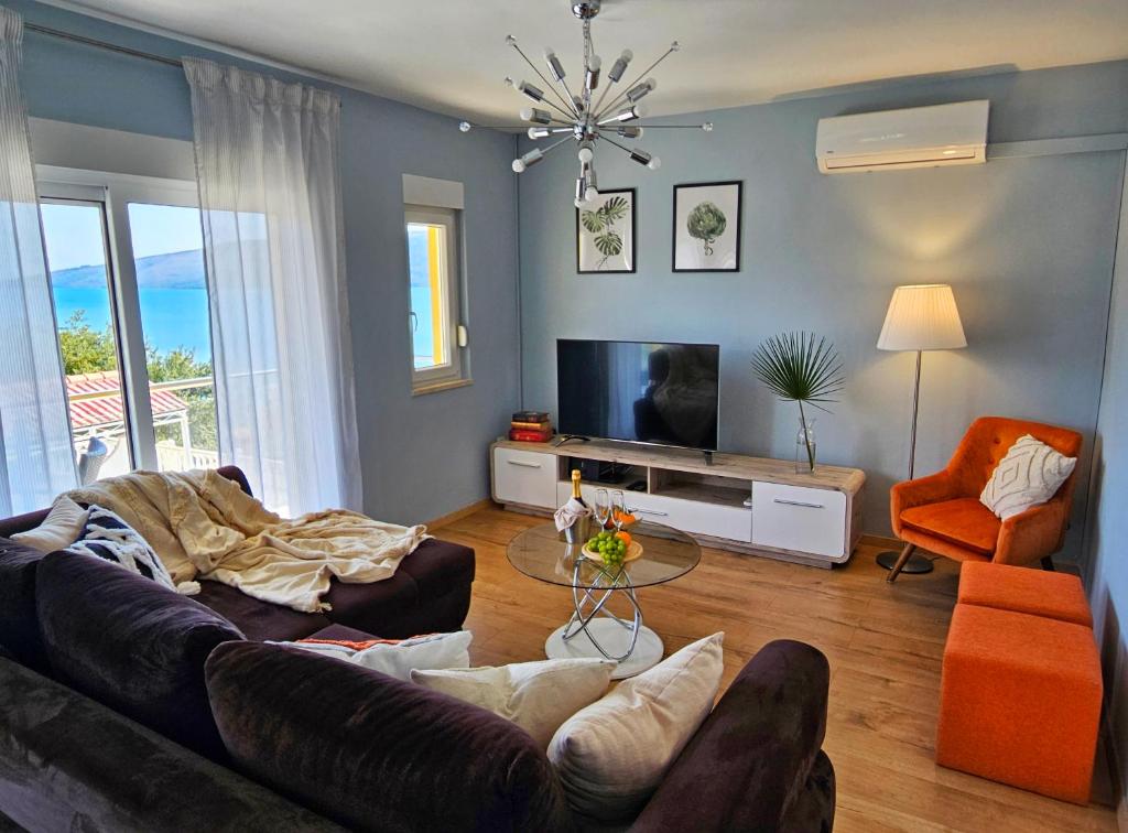 a living room with two couches and a television at Guest House Bona Dea - Trogir Area in Marina
