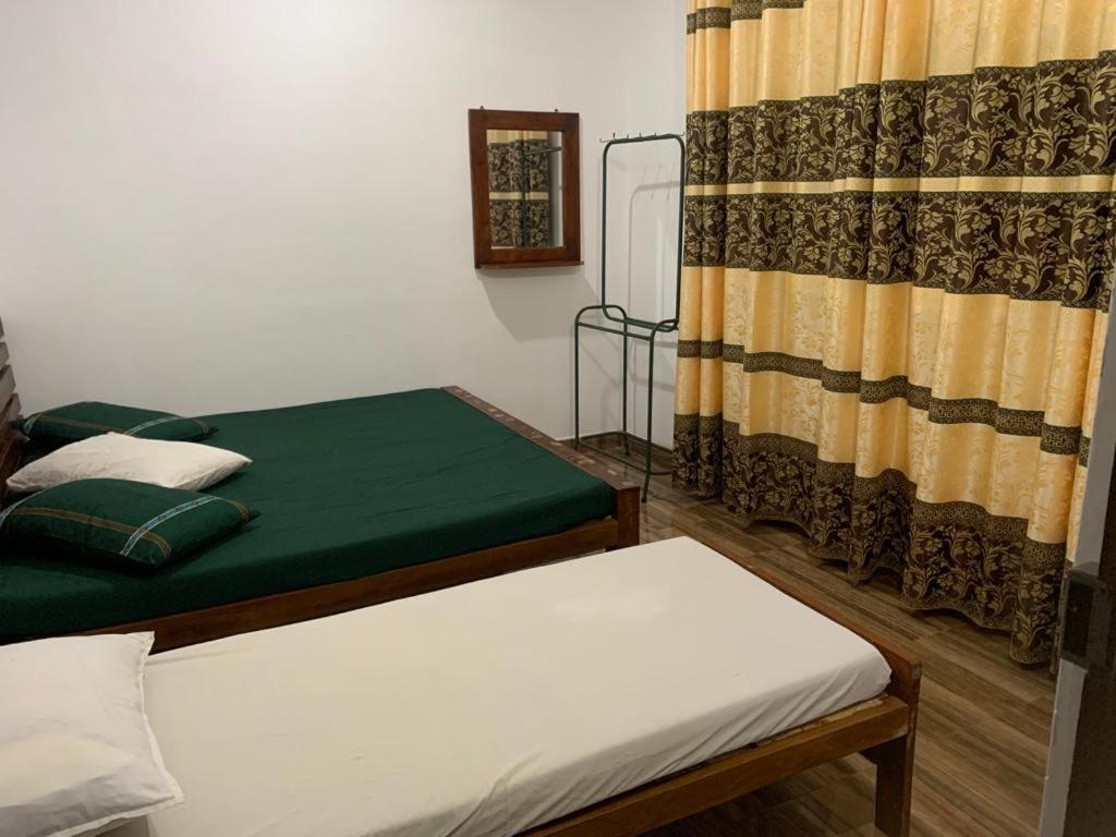 Postel nebo postele na pokoji v ubytování Kumudu Holiday Home