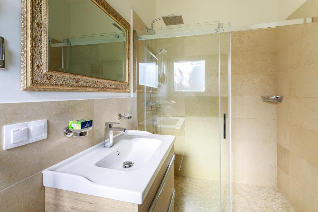a bathroom with a sink and a shower with a mirror at Sea terace apartment between Nice and Monaco - 3 in Villefranche-sur-Mer
