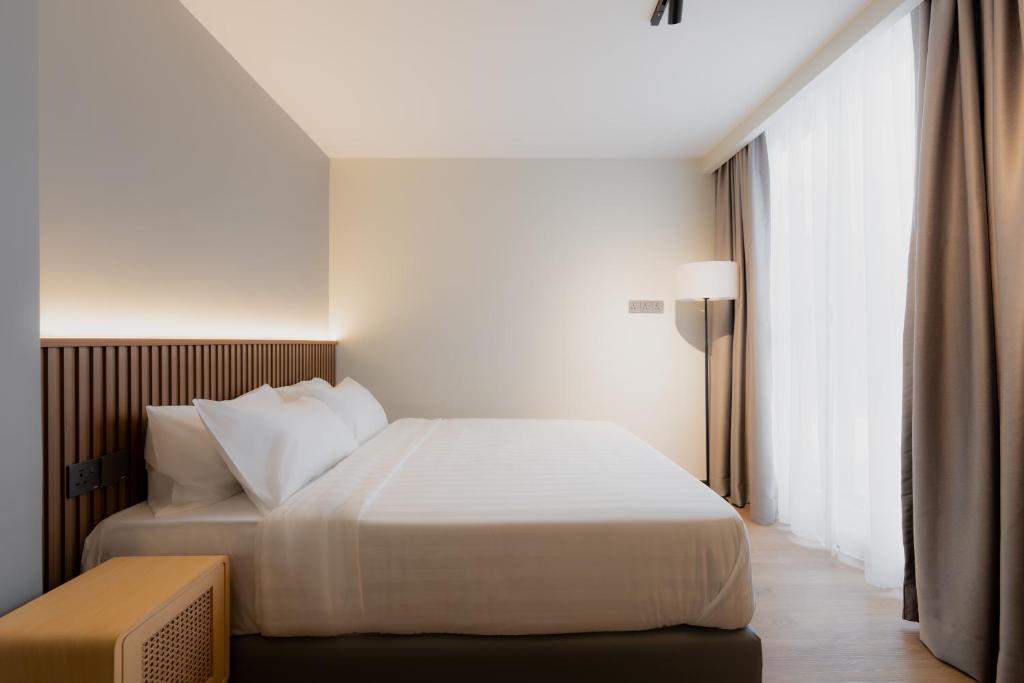 Postel nebo postele na pokoji v ubytování Matata Hotel Kota Kinabalu