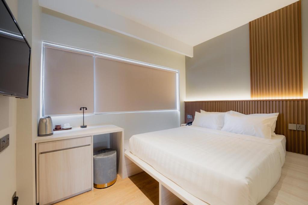Postel nebo postele na pokoji v ubytování Matata Hotel Kota Kinabalu