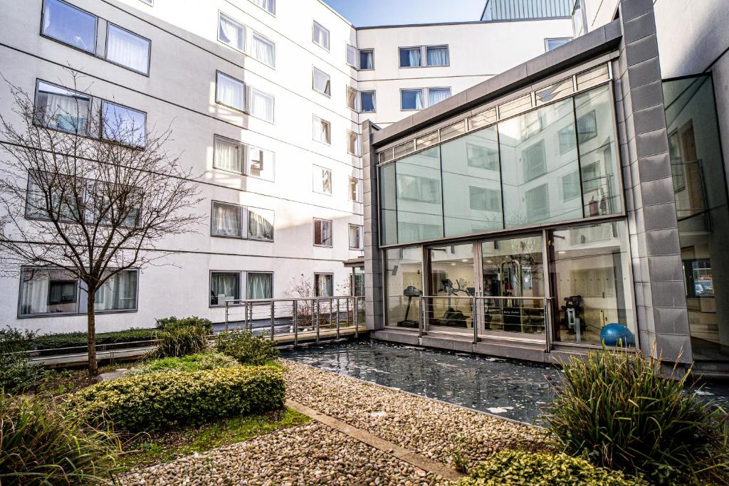 a large building with glass windows in a courtyard at Friendship House (Southwark) in London