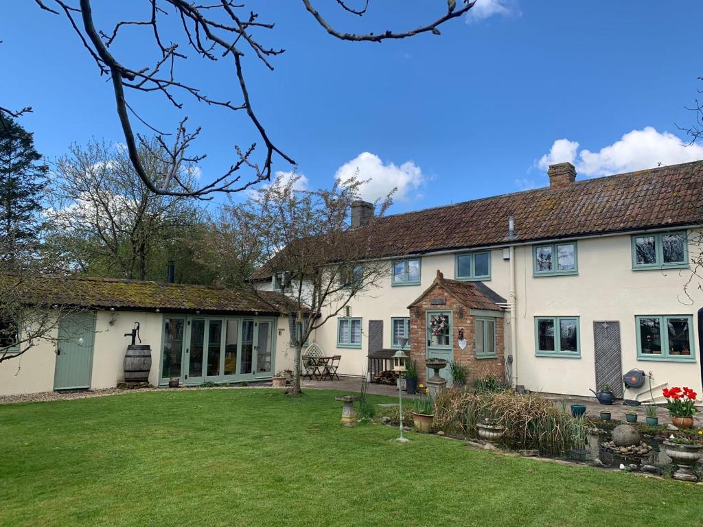 an exterior view of a house with a yard at The Nest at Walnut Cottage in Burrowbridge