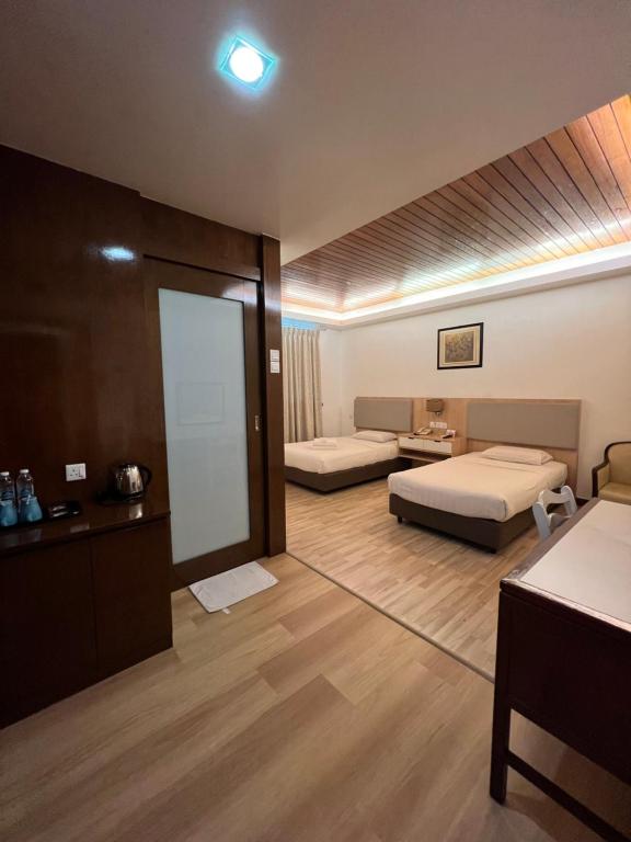Postel nebo postele na pokoji v ubytování D Eastern Hotel