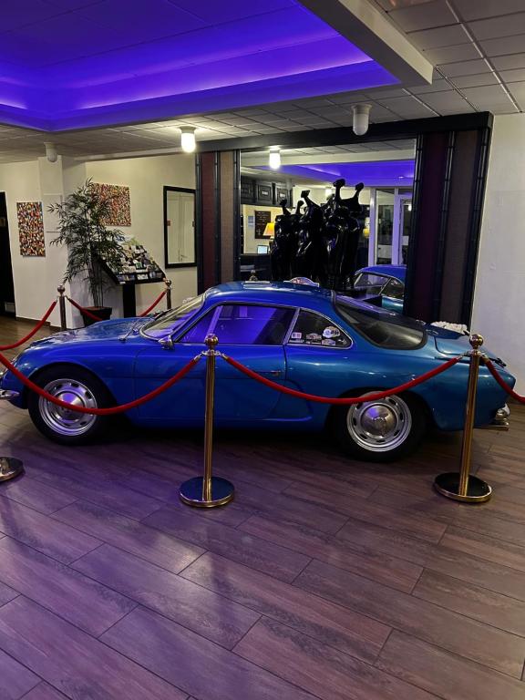 a blue car is parked in a room at Hotel de l&#39;Europe in Dieppe