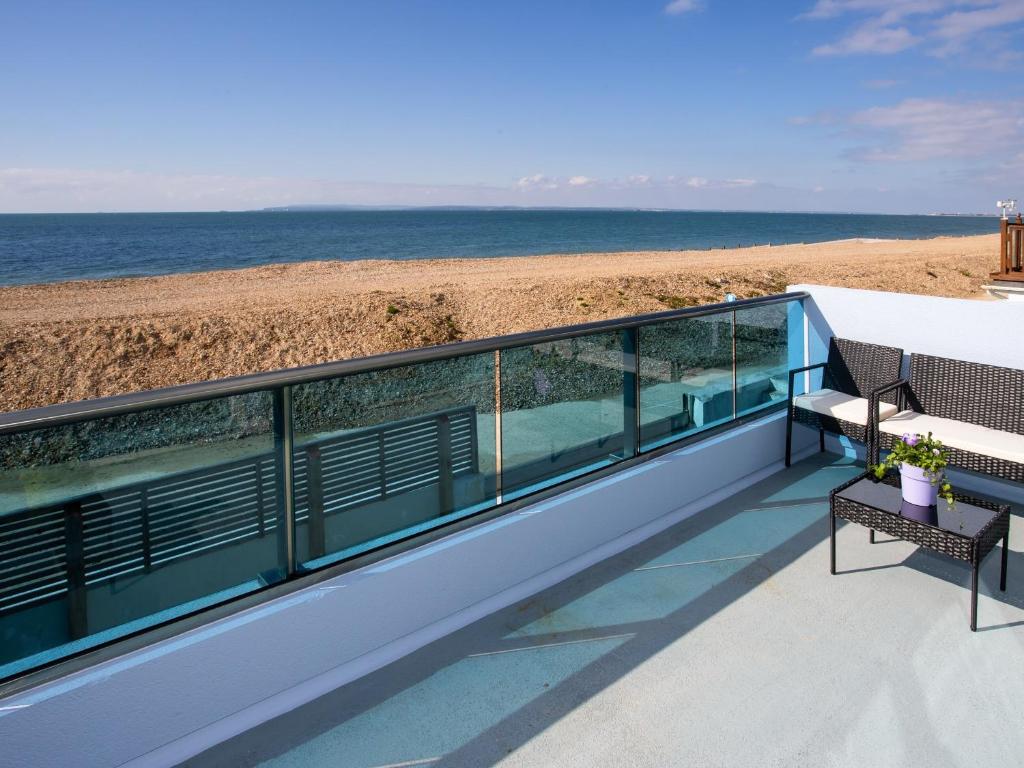 a balcony with a view of the beach at Dreamcatcher in South Hayling