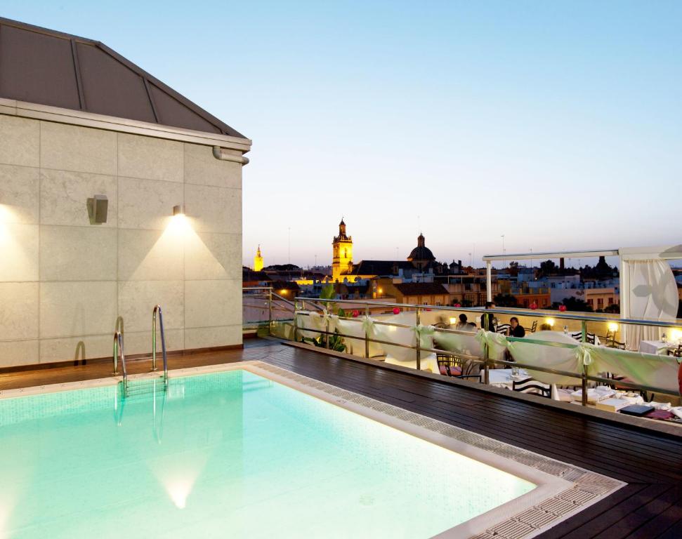 a swimming pool on the roof of a building at Hotel Sevilla Center in Seville