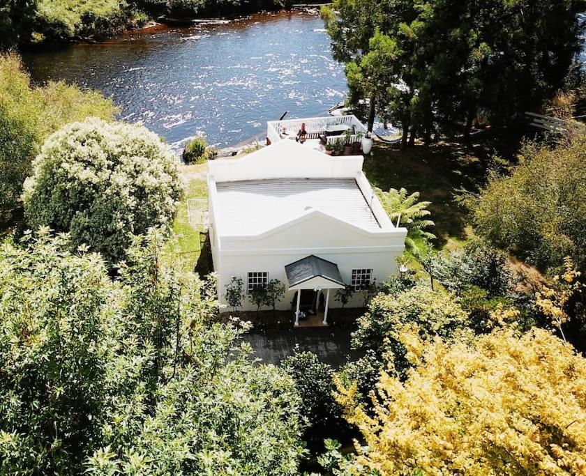 an aerial view of a white house next to a river at Forth River Cottage in Forth