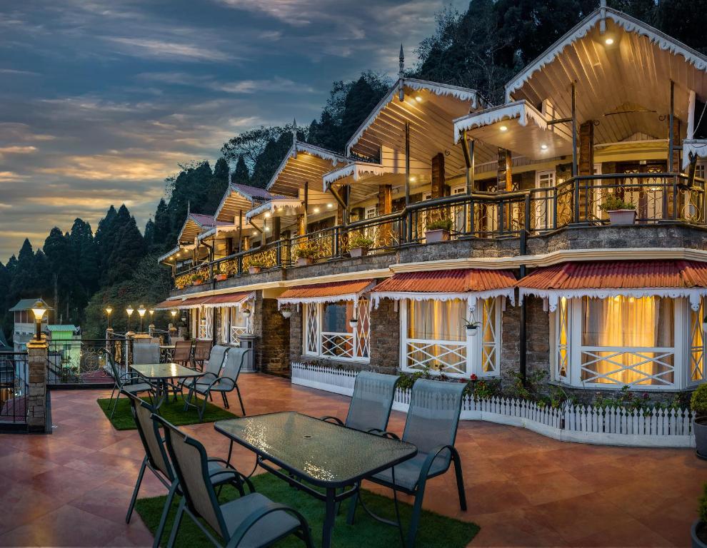 a hotel with tables and chairs in front of a building at Summit Grace Boutique Hotel & Spa in Darjeeling