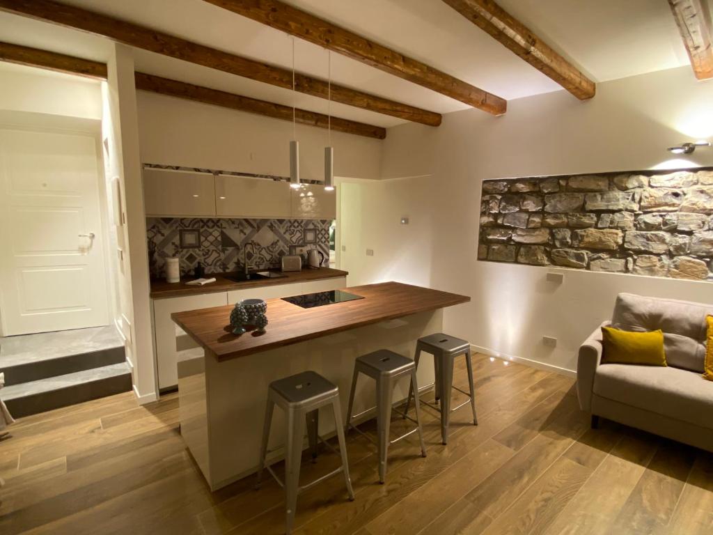 una cucina con isola, sgabelli e divano di LaLucia Luxury Suite Lake Como ad Argegno