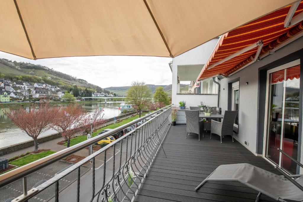 a balcony of a house with a view of a river at Haus Moselwelt - Tilda in Zell an der Mosel