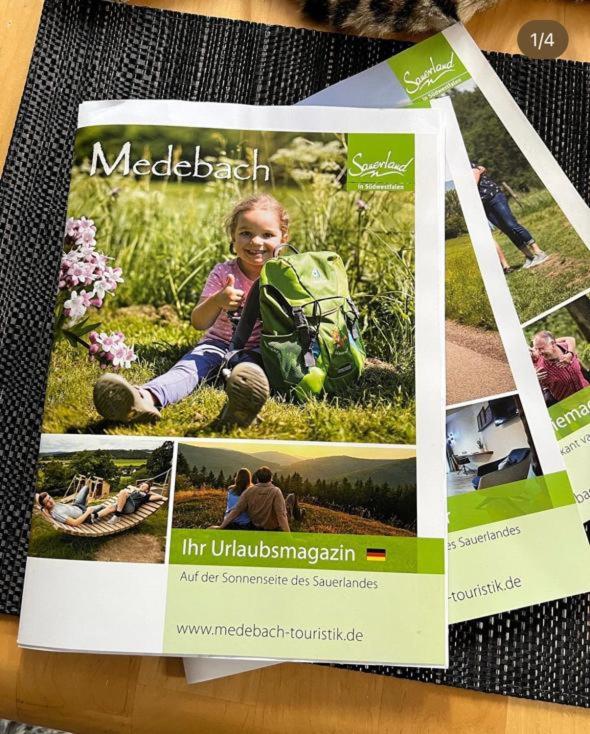 a magazine with a picture of a little girl with a backpack at Ferienwohnung Parkblick Medebach in Medebach
