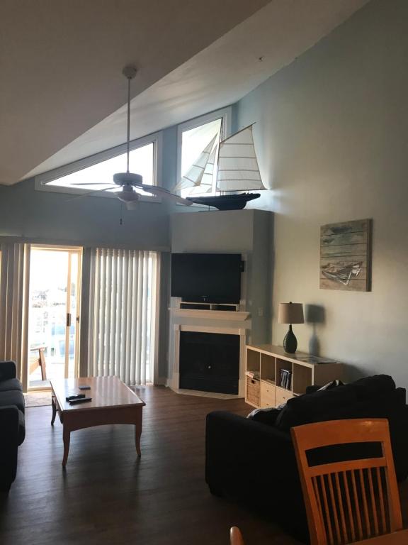 a living room with a black couch and a table at Beautiful Condo in Ocean City