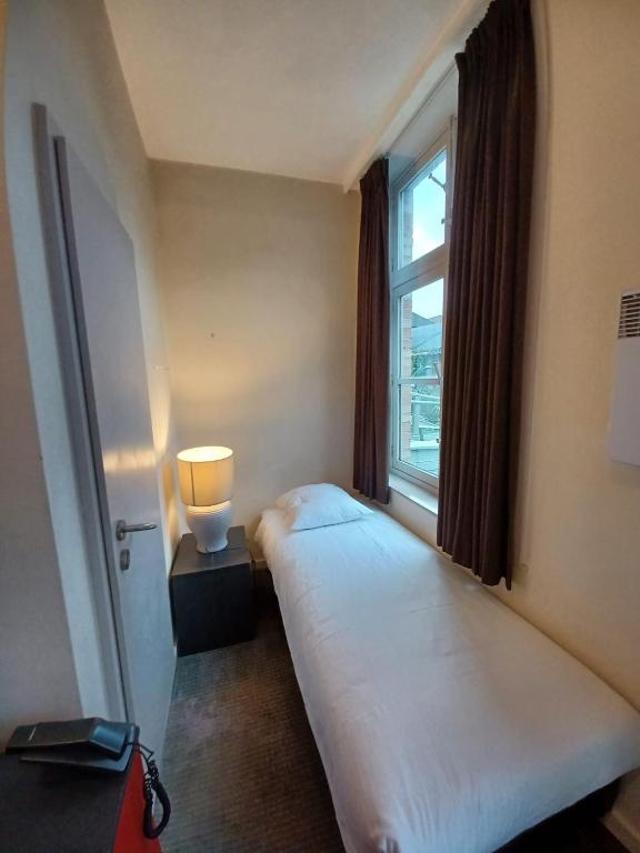 Postel nebo postele na pokoji v ubytování Hotel Koffieboontje