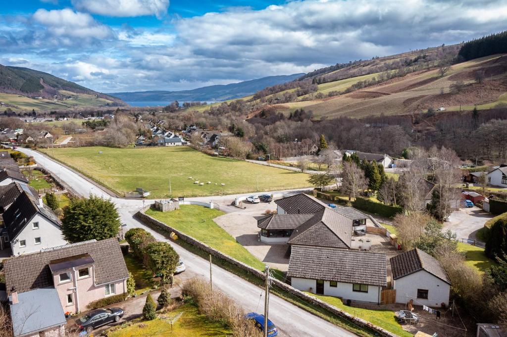 an aerial view of a village with houses and a road at Balmridge House, Loch Ness, Bed & Breakfast in Drumnadrochit