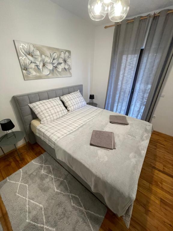 a bedroom with a large bed with two boxes on it at Apartman ANA in Vrlika