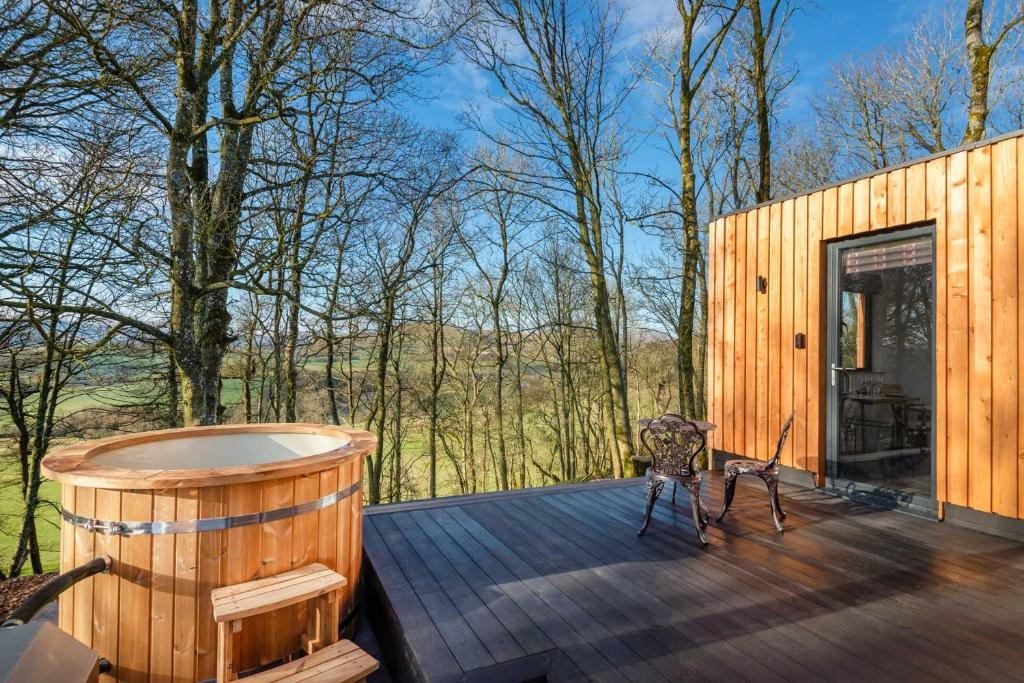 a wooden deck with a jacuzzi tub on it at Oak Tree, Penruddock in Penruddock