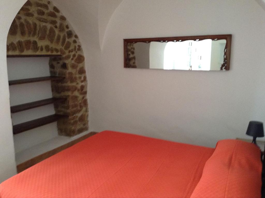 a bedroom with a red bed and a window at Casa SILVIO in Sesta Godano