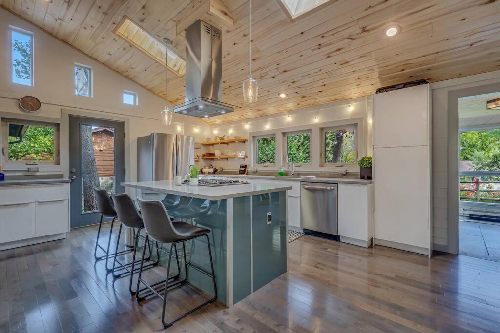 a kitchen with a large island with bar stools at Cozy Modern House seconds from Roaring Fork River in Glenwood Springs