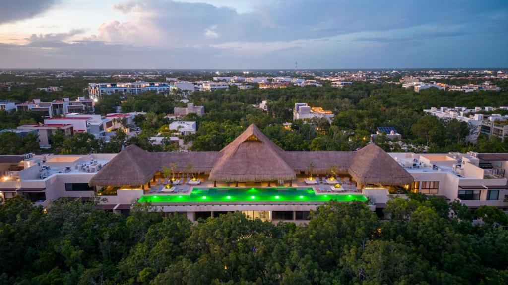 a large building with green lights on top of it at Luxury & Modern Apartments in Tulum Top Amenities By Yeah in Tulum