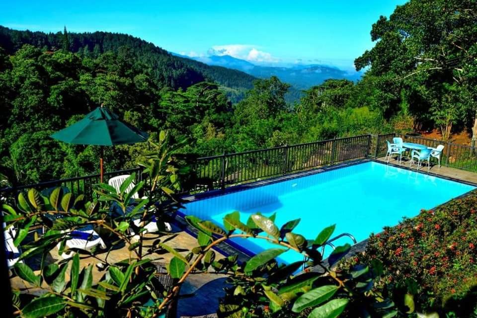 a swimming pool with a view of the mountains at The Grand Hills in Kandy