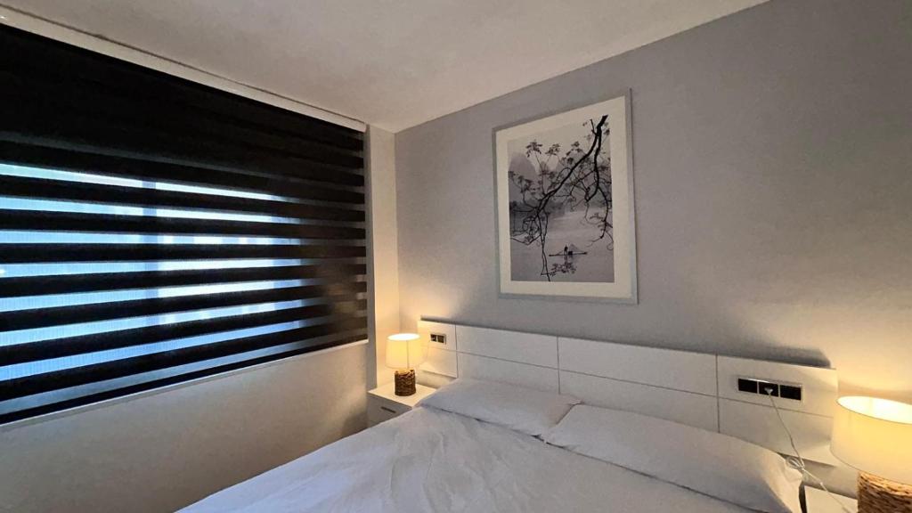 Postel nebo postele na pokoji v ubytování Apartamentos LOS TULIPANES