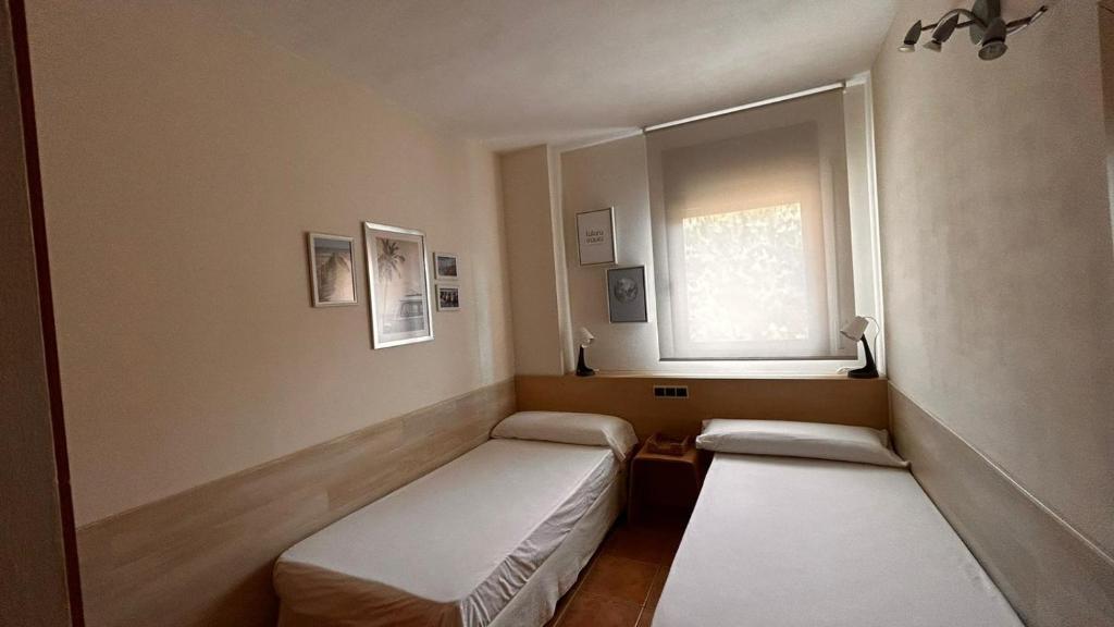 Postel nebo postele na pokoji v ubytování Apartamentos LOS TULIPANES