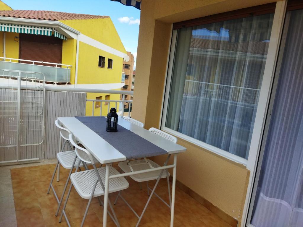 a table and chairs on the balcony of a house at CAMBRILS BEACH APARTMENT in Cambrils