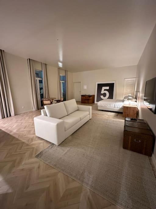 a living room with a white couch and a television at Downtown collection apartments in Funchal