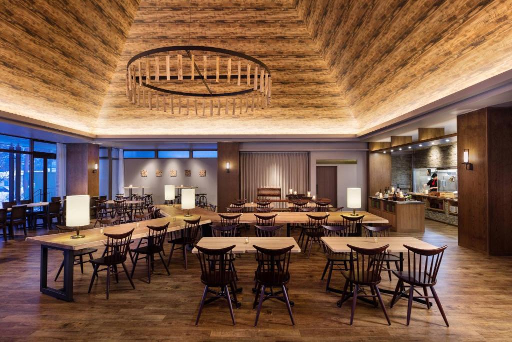 a large dining room with tables and chairs at Courtyard by Marriott Hakuba in Hakuba