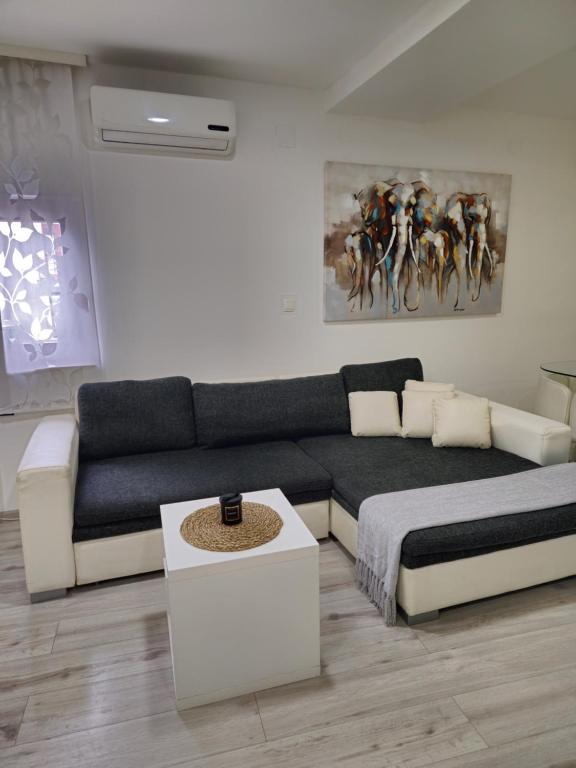 a living room with a bed and a couch at Apartment Aria in Vinkovci