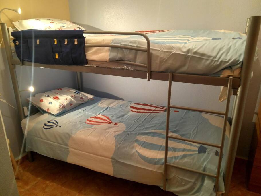 a couple of bunk beds in a room at La casita de colores in Elche