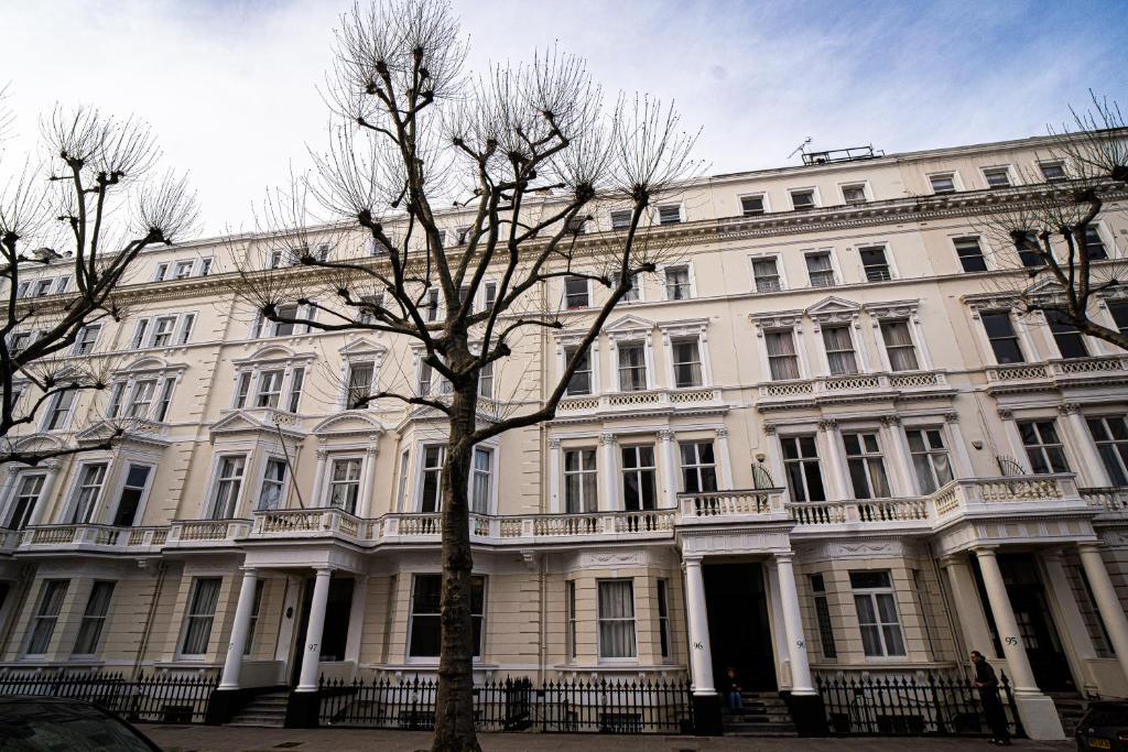 a large white building with a tree in front of it at Halpin House (South Kensington) in London