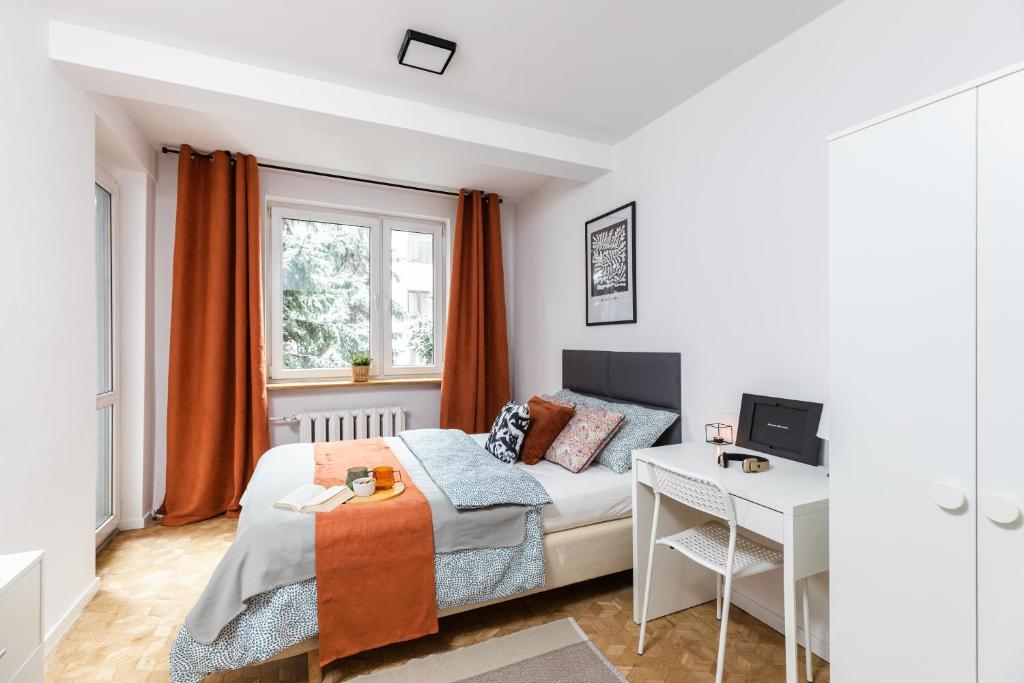 a small bedroom with a bed and a desk at SuperApart Bohaterów Września ROOMS in Warsaw