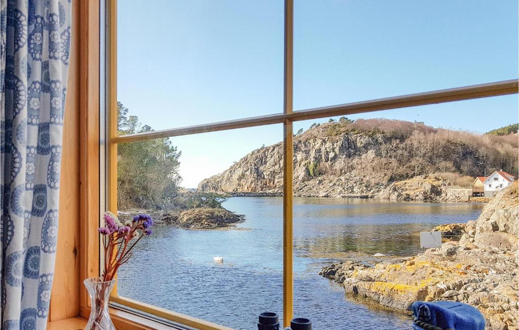 a window with a view of a body of water at Beautiful Home In Finns With 2 Bedrooms in Lykling
