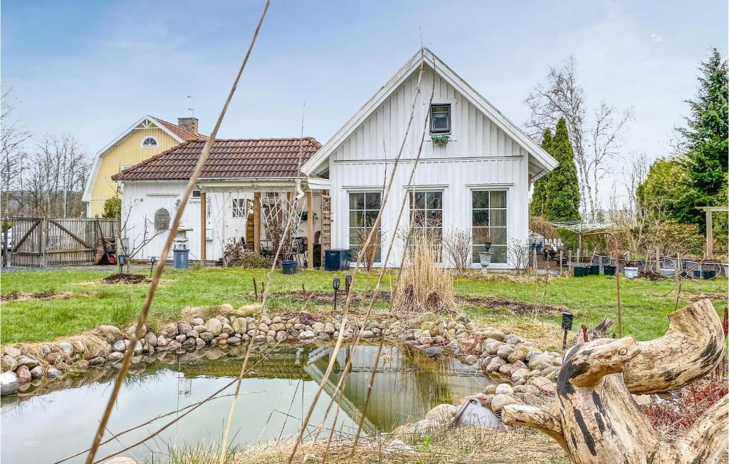 a house with a pond in front of it at Nice Home In Skene With Kitchen in Skene