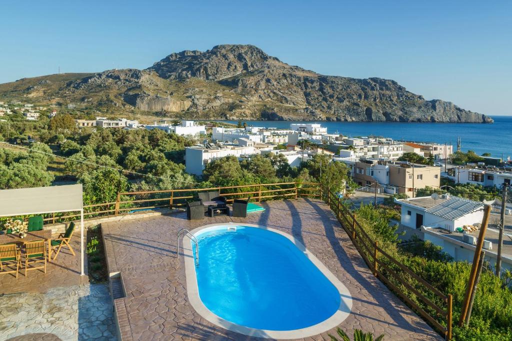 a villa with a pool and a view of the ocean at Family Villa Ellis Plakias with private pool 200m to the beach walking distance to the amenities in Plakias
