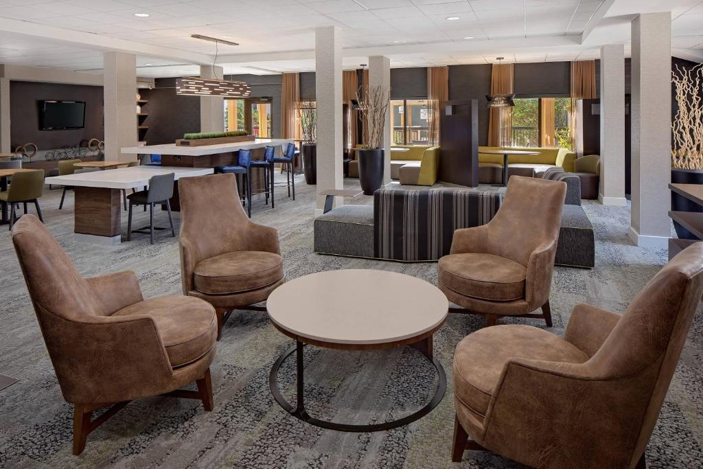 a lobby with chairs and a table and a living room at Courtyard Fort Worth I-30 West Near NAS JRB in Fort Worth