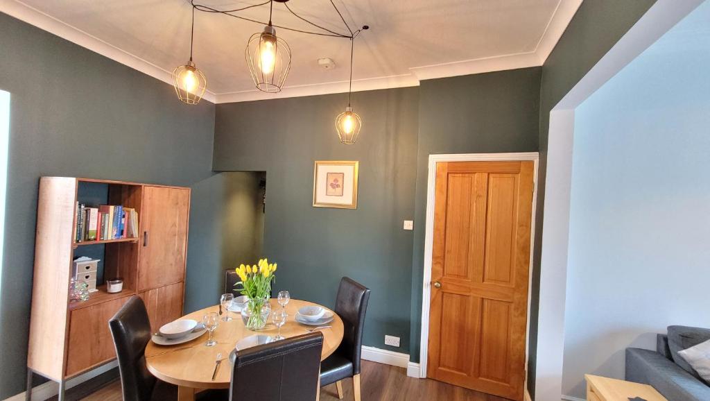 a dining room with a table and chairs at Colenso St - 2 bed house by Bishy Road & River in York