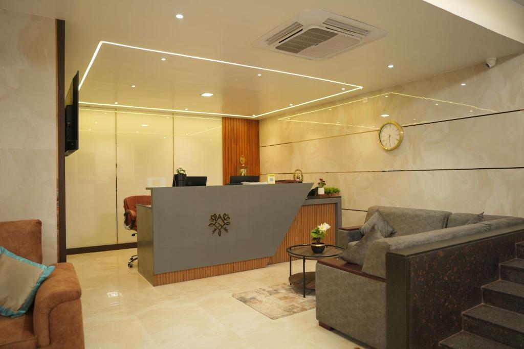 a lobby with a couch and a reception desk at Sri Ambal Grand in Virudunagar