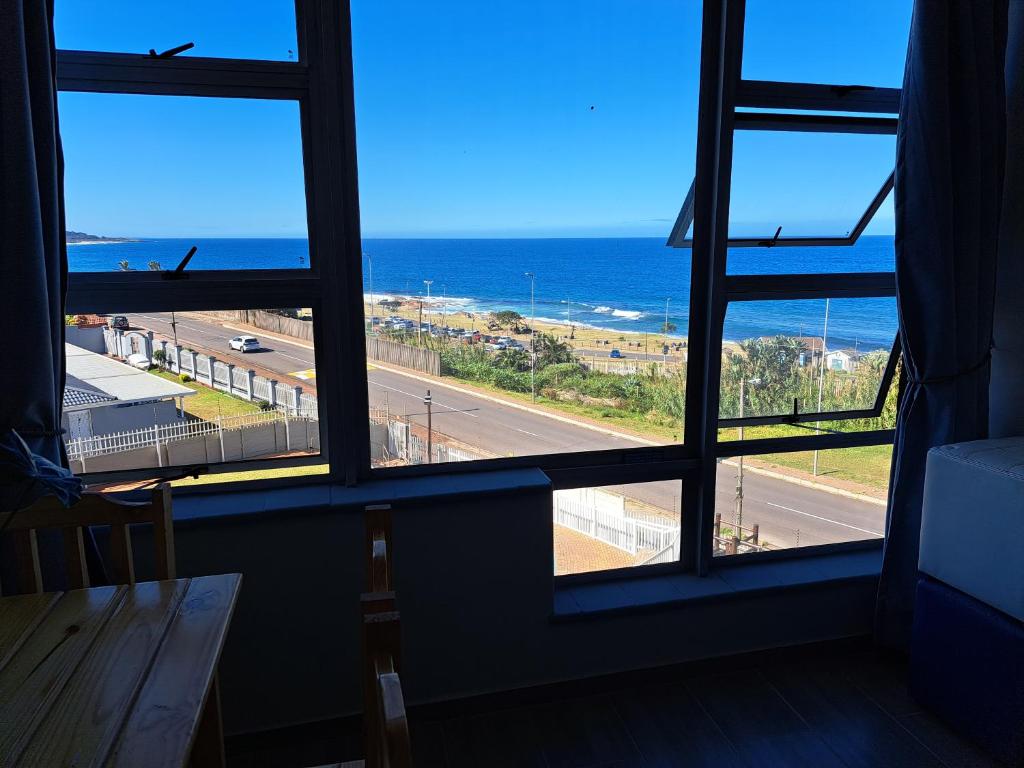 a view of the ocean from a room with windows at Sun Sea Sand Peacehaven Scottburgh in Scottburgh