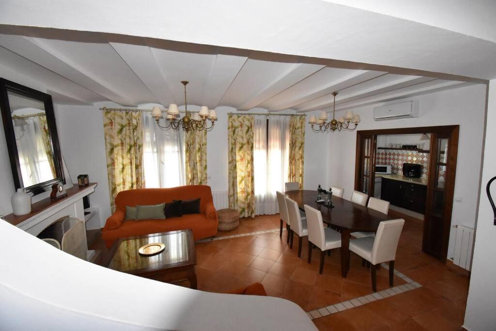a living room with a table and a dining room at Casa Rural Almonaster la Real, Marques de Robledal in Almonaster la Real